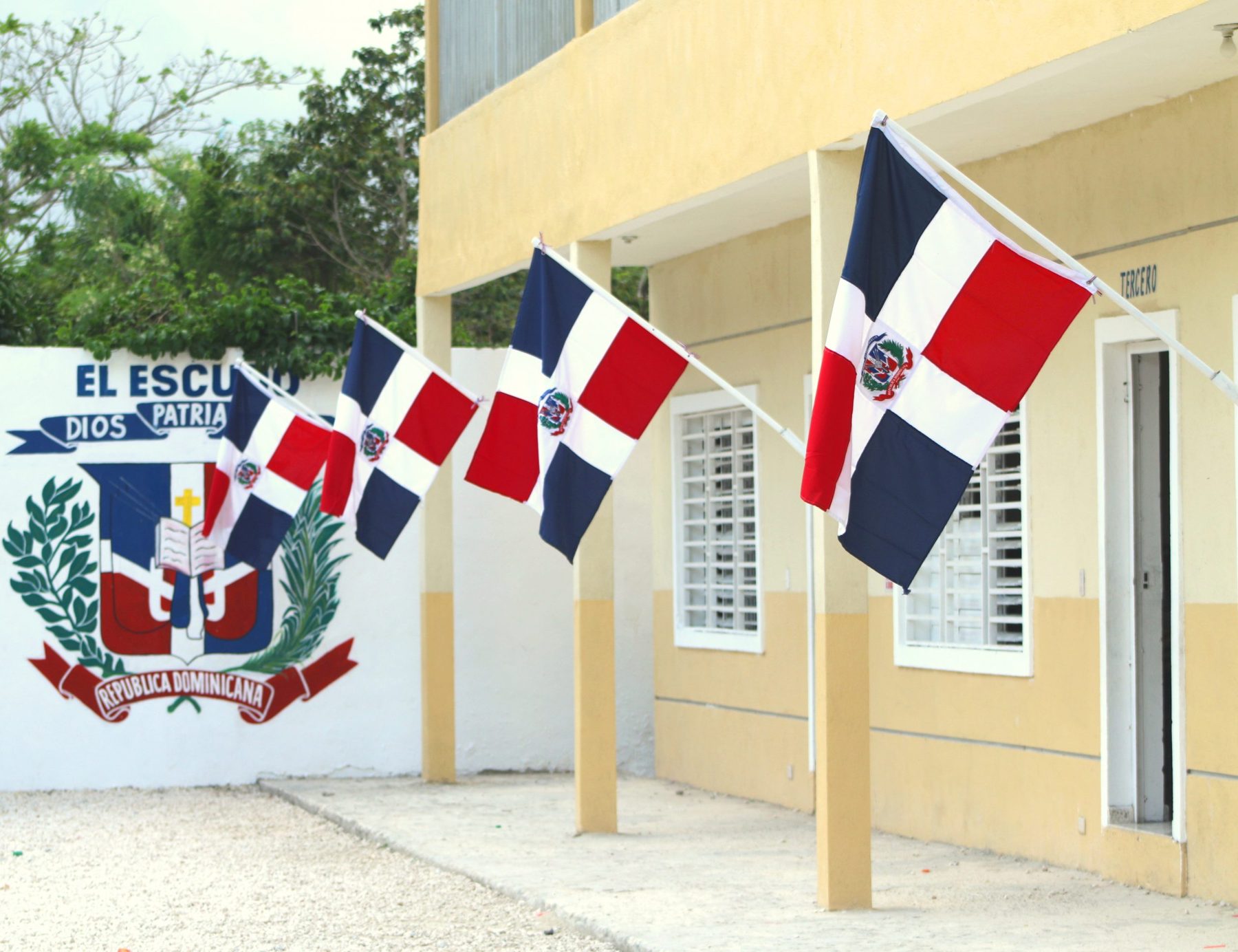 Facade of the Rodney Henrikson Educational Center with Dominican flags